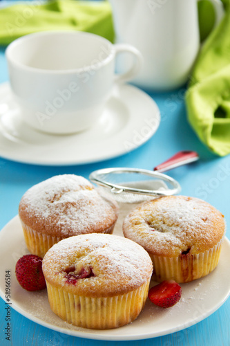 Strawberry muffins on a wooden board.