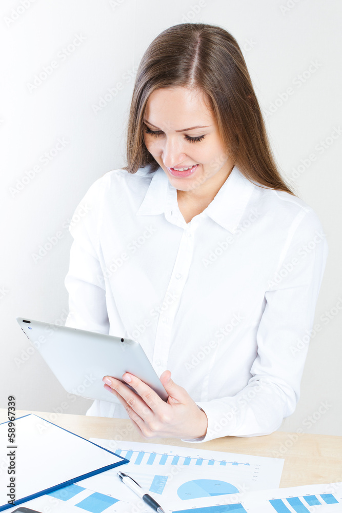 Happy young businesswoman using tablet computer Happy young businesswoman using tablet computer