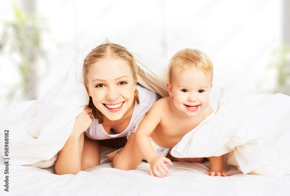 happy family mother and baby under blankets in bed happy family mother and baby under blankets in bed