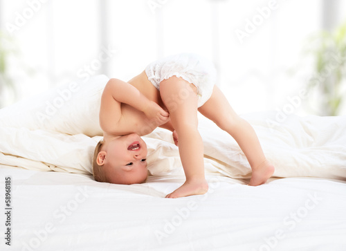 Tableau sur toile happy baby child playing   in bed