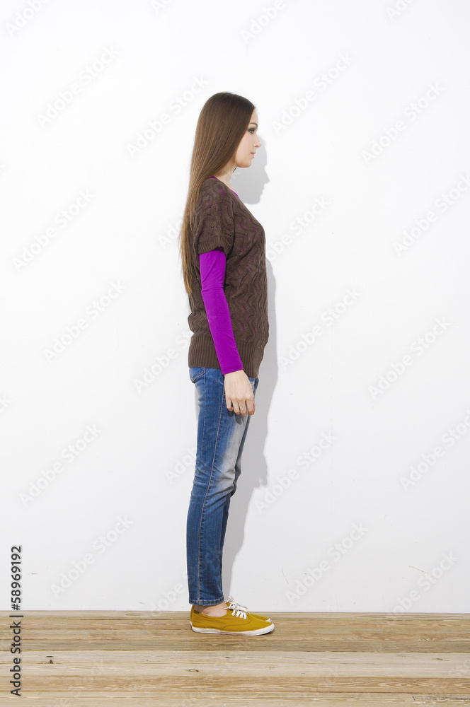 Full length attractive young girl in jeans standing Full length attractive young girl in jeans standing