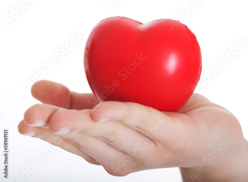 Red heart held on a female s hand.