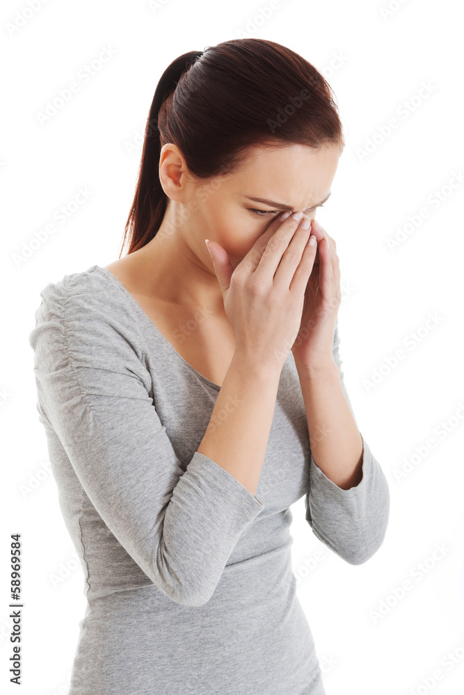 Young beautiful woman touching her nose. Young beautiful woman touching her nose.