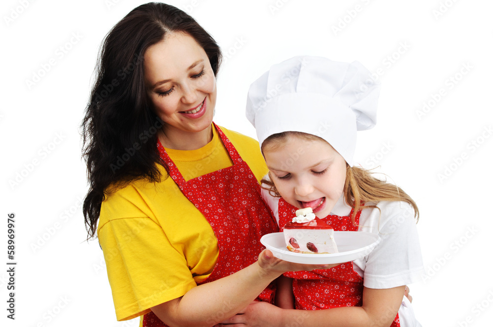 A daughter eating a cake and a mother holding it. A daughter eating a cake and a mother holding it.