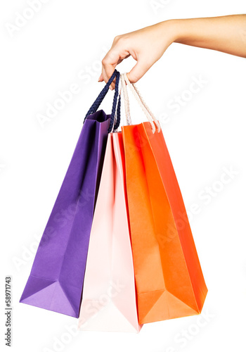 Woman's hand holding colorful shopping bags