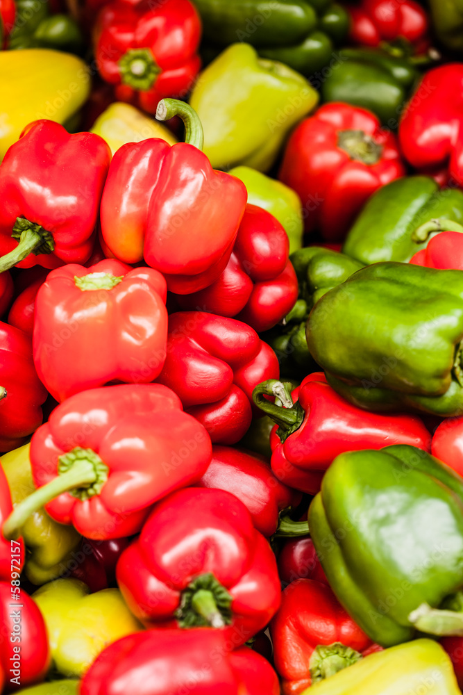 Red, green and yellow sweet bell peppers natural background. Red, green and yellow sweet bell peppers natural background.