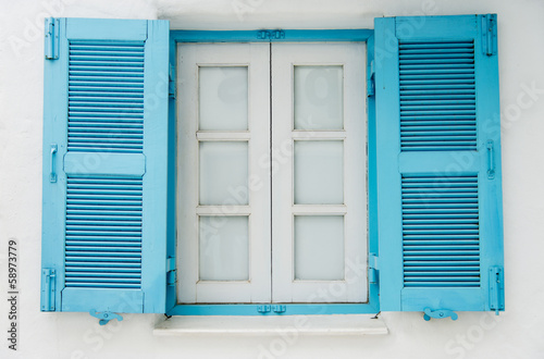 Blue wooden window on white wall