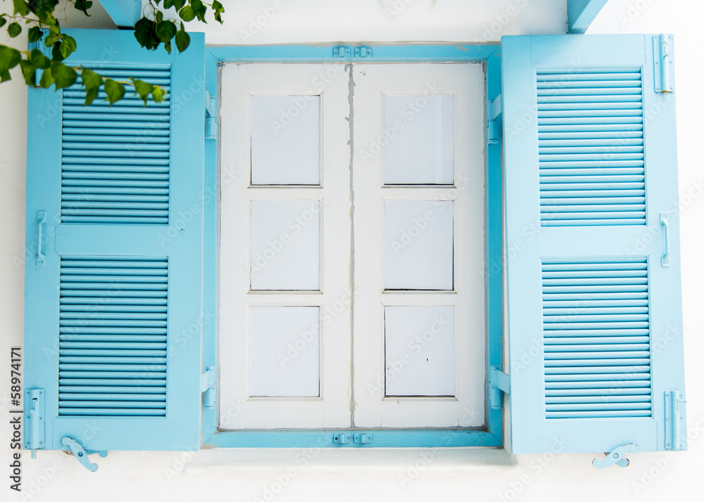 Fototapeta premium Blue wooden window on white wall