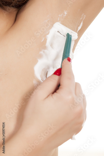close-up of a woman shaving her armpits