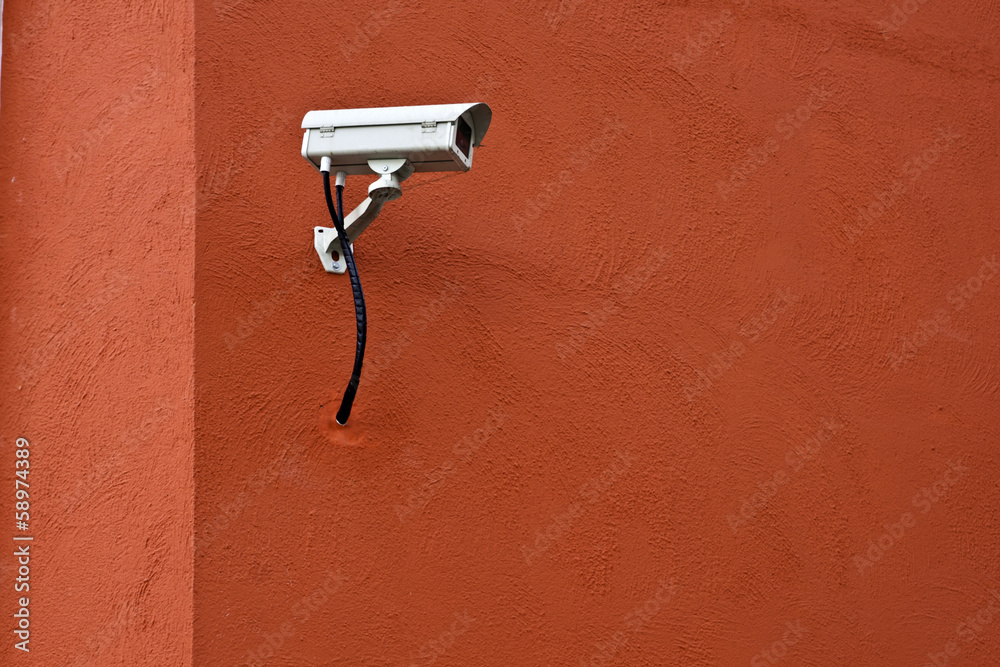 CCTV security camera and red wall. CCTV security camera and red wall.