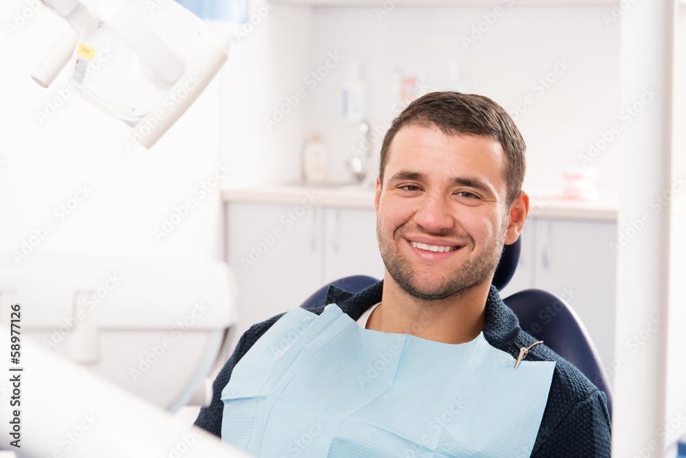 Fototapeta premium Smiling young man at dentist's surgery