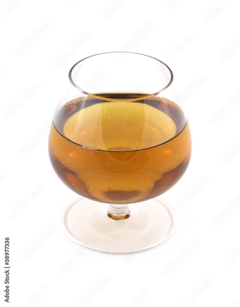 Glass with amber wine isolated on white close up