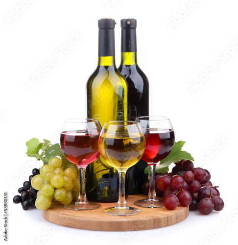 bottles and glasses of wine and assortment of grapes, isolated