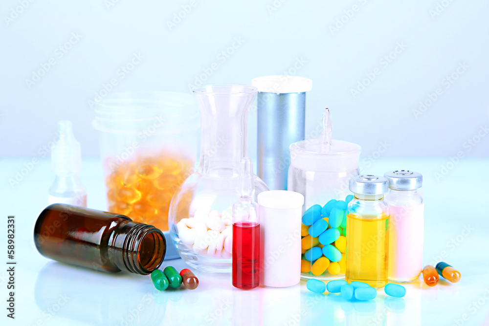 Medical bottles and pills isolated on white