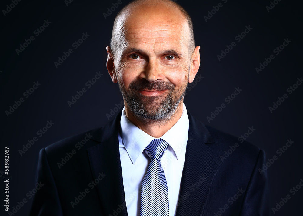 Portrait of the elderly man. A photo against a dark background Portrait of the elderly man. A photo against a dark background