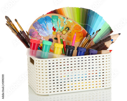 фотографія Plastic basket with art supplies isolated on white