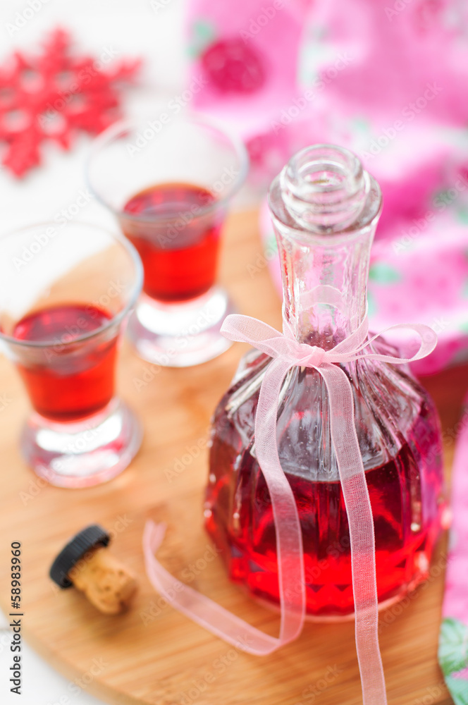 A Bottle and Two Shots of Homemade Raspberry Liqueur A Bottle and Two Shots of Homemade Raspberry Liqueur