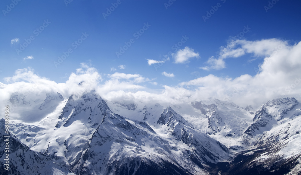 Panorama of snowy mountains in clouds Panorama of snowy mountains in clouds