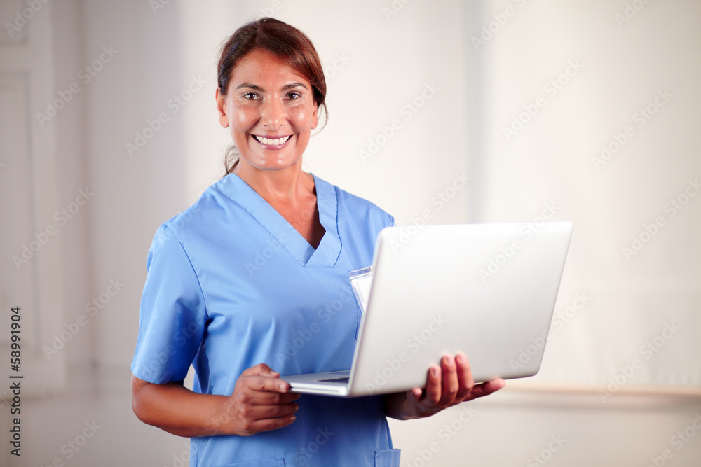 Professional female doctor holding a laptop Professional female doctor holding a laptop