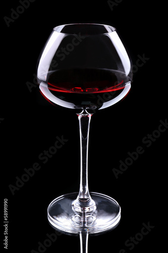 Wineglass with red wine  isolated on black