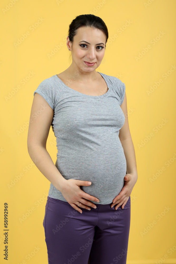 Beautiful young pregnant woman touching her belly Beautiful young pregnant woman touching her belly
