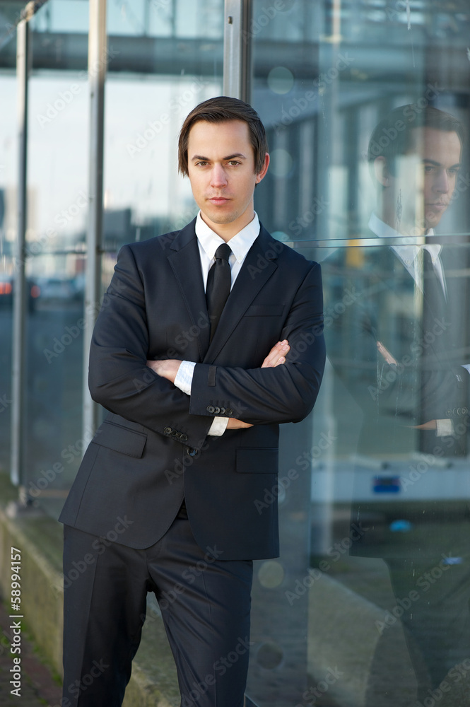 Young businessman standing outdoors Young businessman standing outdoors