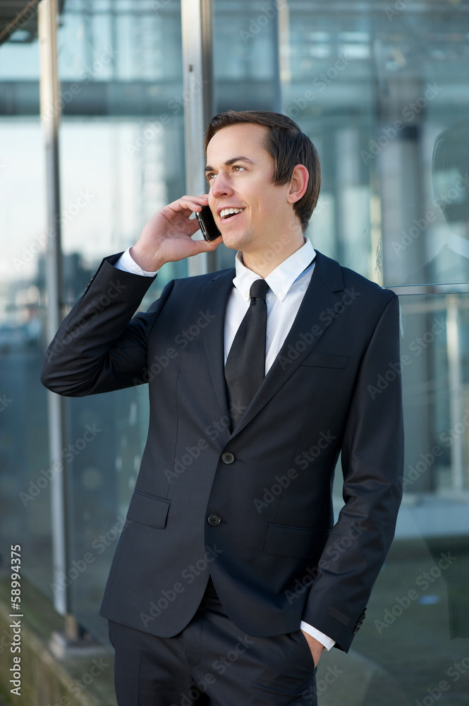 Young business man talking on mobile phone outdoors Young business man talking on mobile phone outdoors