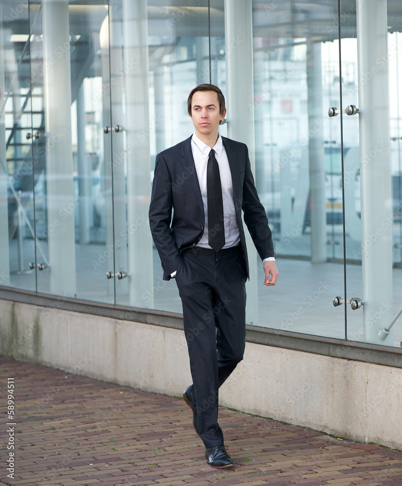 Portrait of an attractive businessman walking in the city Portrait of an attractive businessman walking in the city