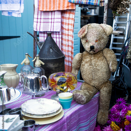 100 years old sad teddy bear on flea market photo