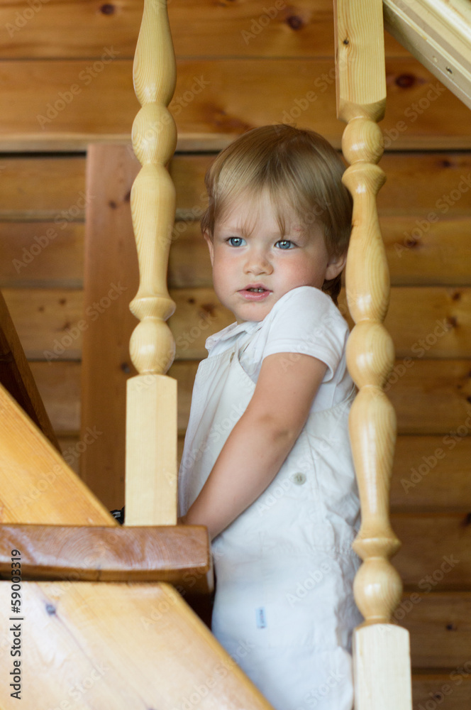 Child standing on a wooden staircase Child standing on a wooden staircase