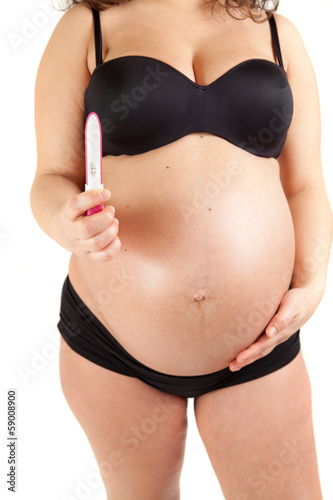 pregnant woman holding a positive pregnancy test.