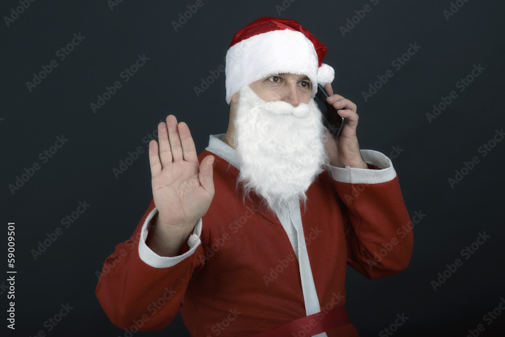 Portrait of Santa talking on mobile looking at camera, isolated Portrait of Santa talking on mobile looking at camera, isolated