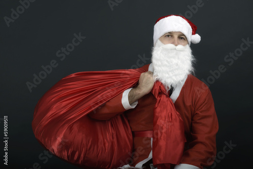 Santa Claus with christmas sack isolated on black background