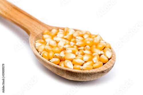 Wooden Spoon With Corn Seeds On White