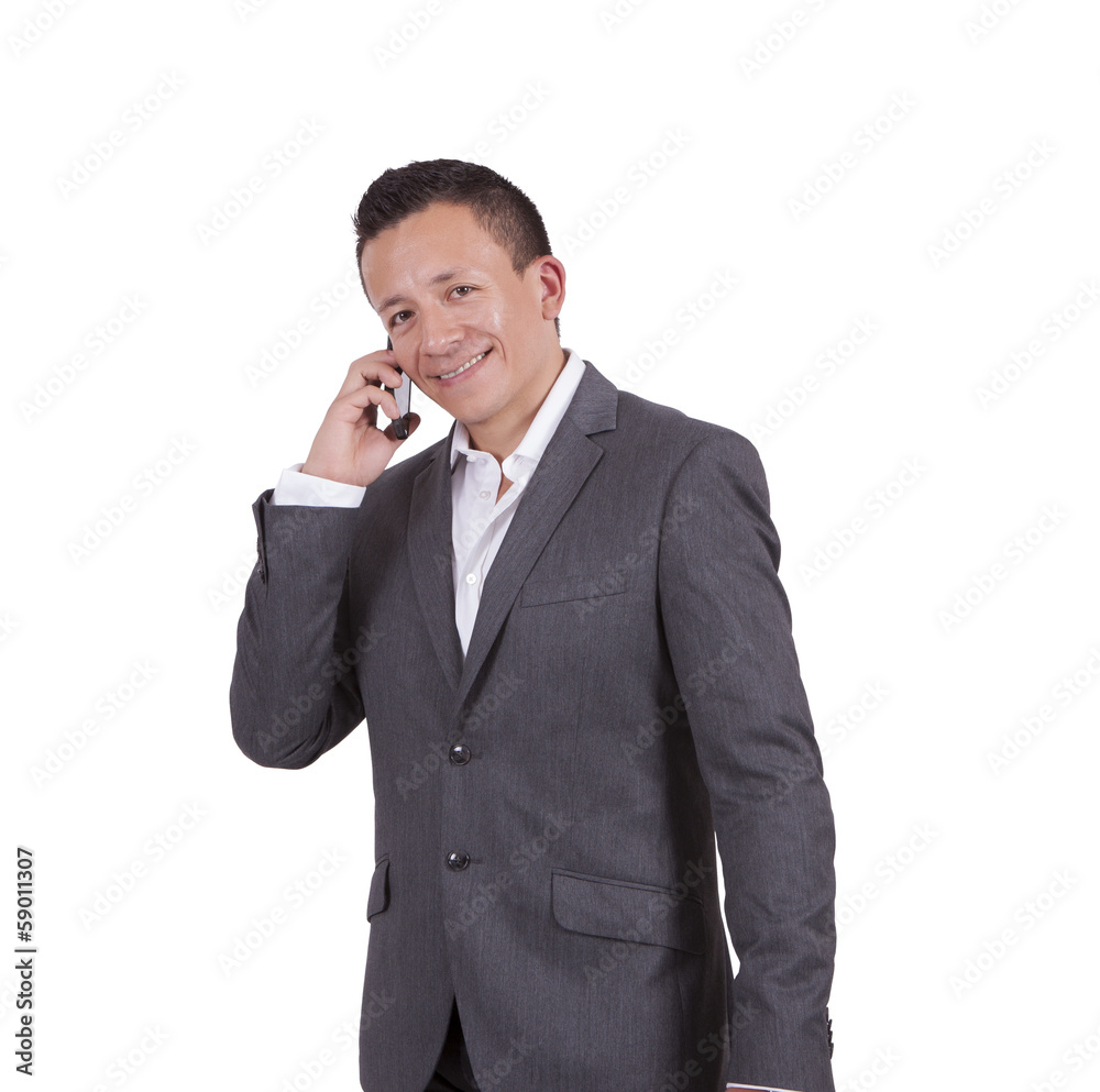 Smiling young businessman talking on cell phone Smiling young businessman talking on cell phone
