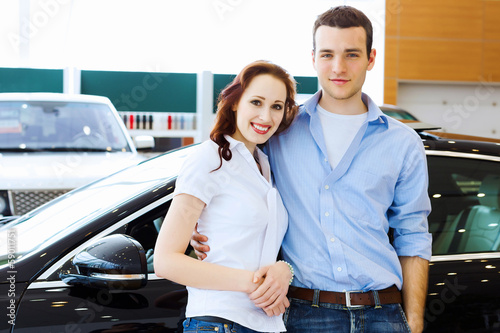 Young happy couple at car salon © Sergey Nivens