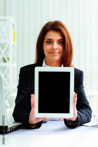 Young beautiful businesswoman showing display 