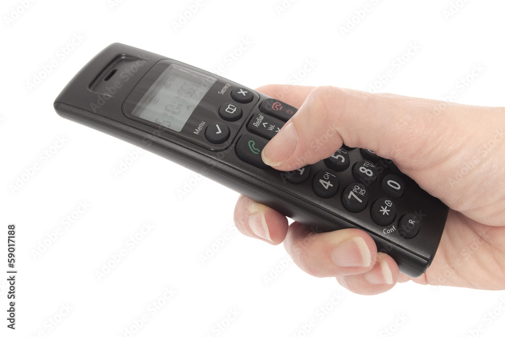 Woman's hand holding a cordless telephone Woman's hand holding a cordless telephone