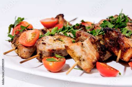 Barbecue on skewers, garnished with cherry