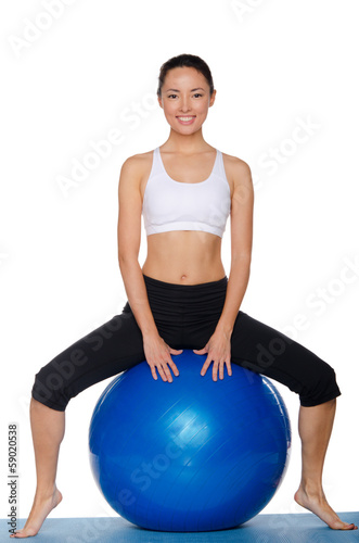 Asian sitting on blue ball