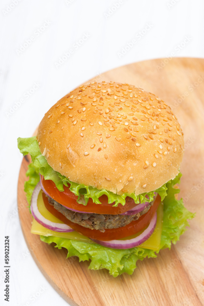 Burger with a vegetarian cutlet and fresh vegetables, top view Burger with a vegetarian cutlet and fresh vegetables, top view