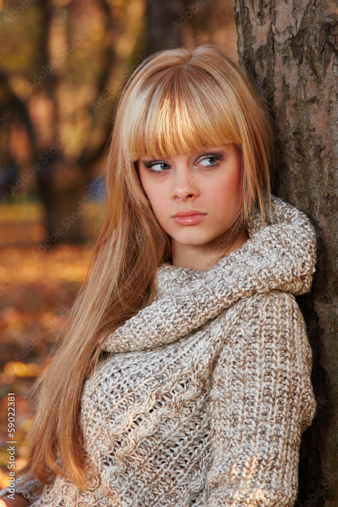 Young woman with autumn garden background Young woman with autumn garden background