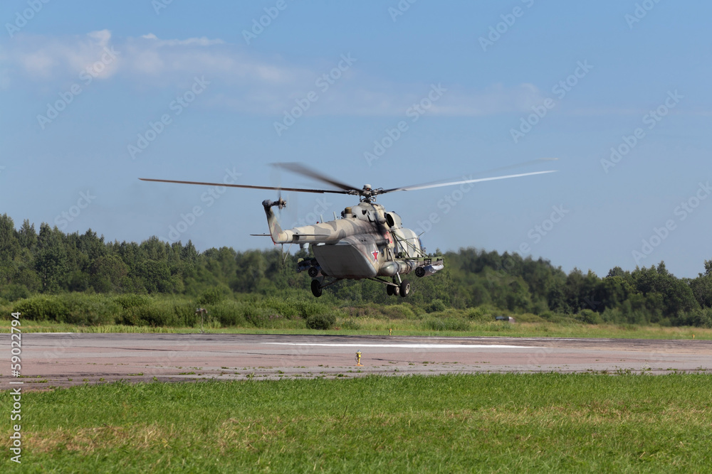 The military helicopter at the airfield preparing for take-off The military helicopter at the airfield preparing for take-off