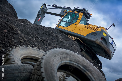 Excavator/Digger on Top of a Rubble Mountain photo