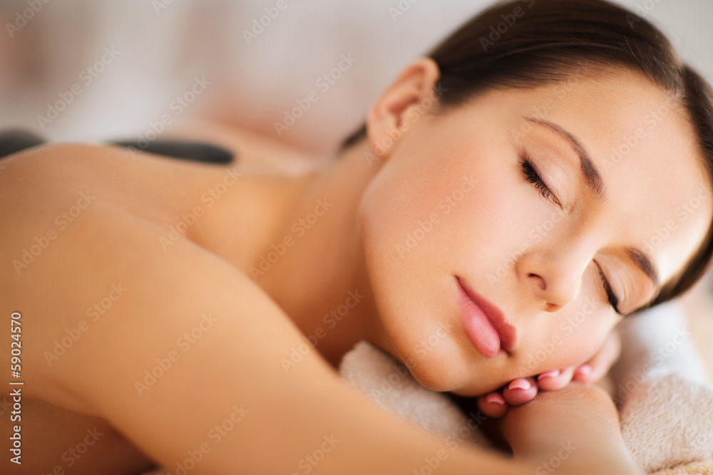 beautiful woman in spa salon with hot stones beautiful woman in spa salon with hot stones