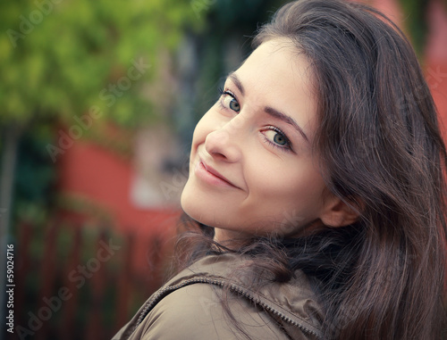 Beautiful smiling woman looking happy outdoors background