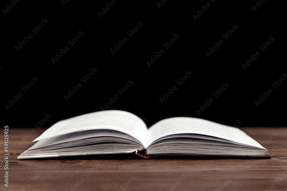 Open book on a wooden table Open book on a wooden table