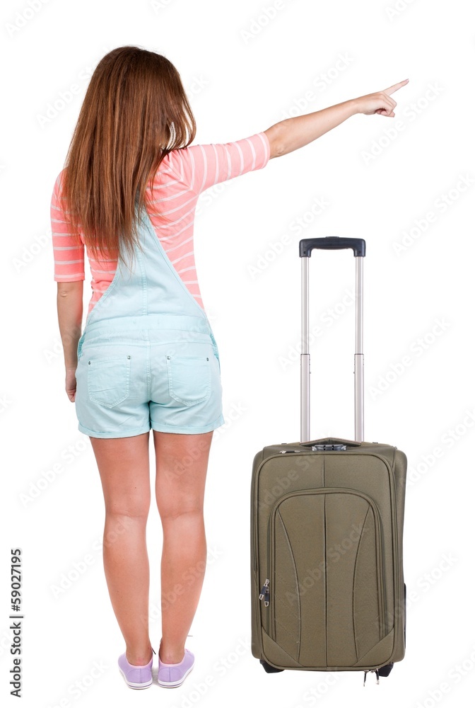Back view of traveling pointing woman with suitcase Back view of traveling pointing woman with suitcase