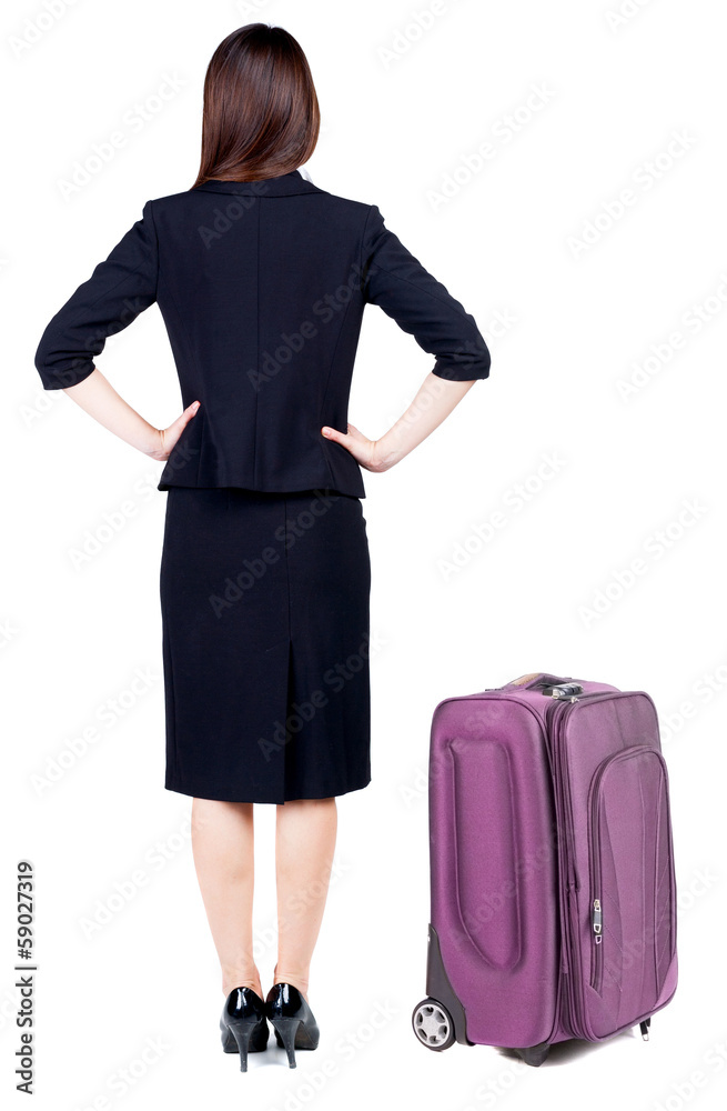 back view of thoughtful business woman traveling with suitcas.