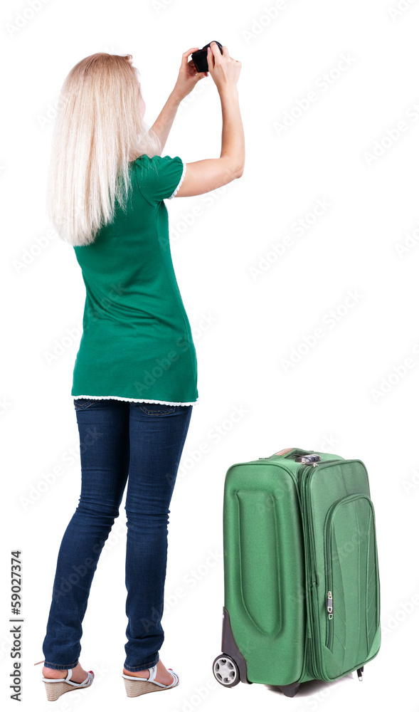 Back view of woman photographing traveling with suitcas. Back view of woman photographing traveling with suitcas.